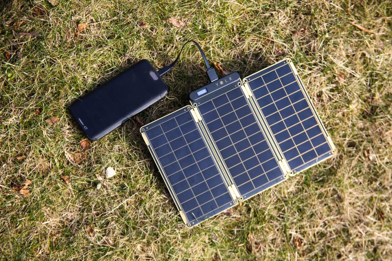 solar phone charger charging the phone on the sun.